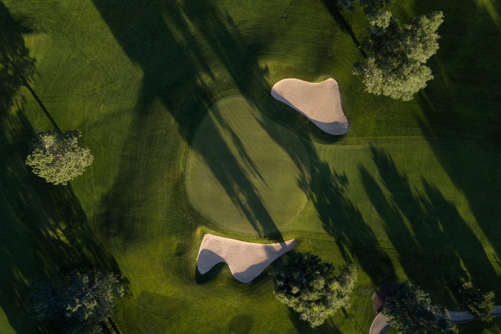 Drone image of a golf course, bunker and green